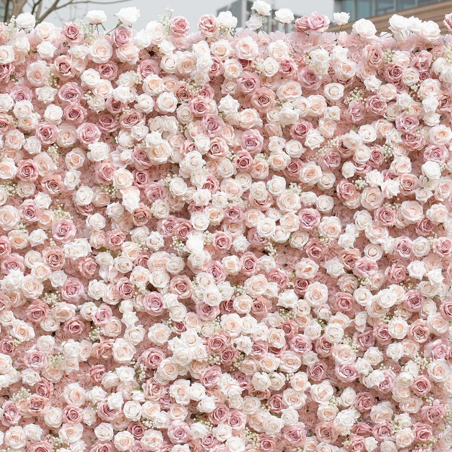 This close-up showcases Valar Flowers’ premium blush pink and white artificial flower wall, featuring a lush gradient of roses, peonies, and delicate filler blooms. The dense, layered arrangement creates a romantic, timeless aesthetic with soft, realistic petals. Maintenance-free and durable, this elegant backdrop is ideal for weddings, photo booths, and luxury events, offering a dreamy, soft-toned look perfect for professional styling.