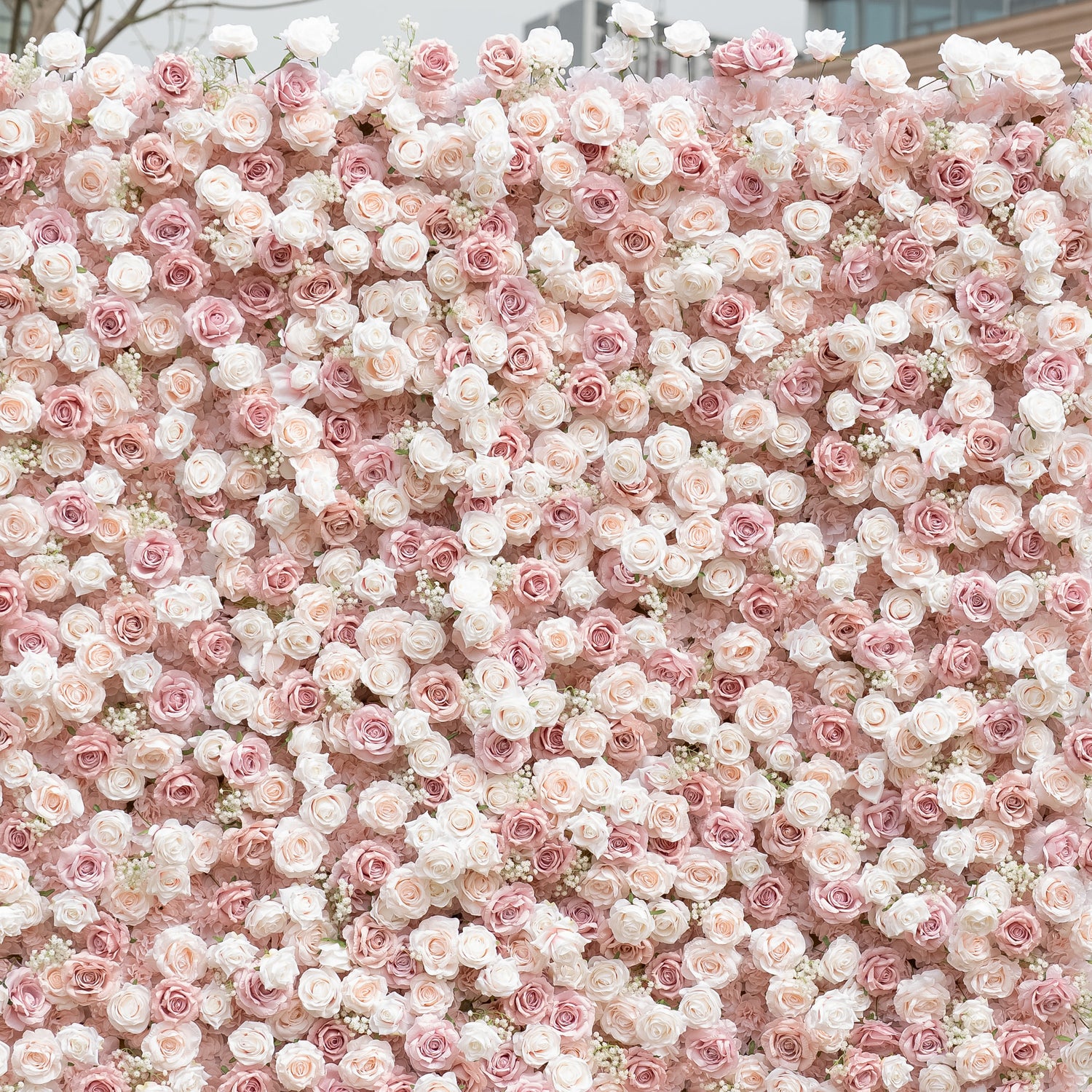 This close-up showcases Valar Flowers’ premium blush pink and white artificial flower wall, featuring a lush gradient of roses, peonies, and delicate filler blooms. The dense, layered arrangement creates a romantic, timeless aesthetic with soft, realistic petals. Maintenance-free and durable, this elegant backdrop is ideal for weddings, photo booths, and luxury events, offering a dreamy, soft-toned look perfect for professional styling.