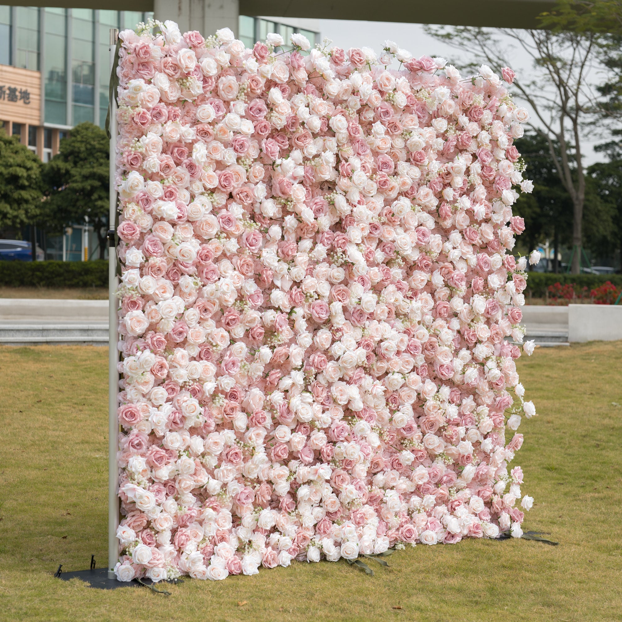 This premium blush pink and white artificial flower wall by Valar Flowers features a lush, gradient arrangement of roses and peonies. The dense, layered design creates a romantic, timeless aesthetic, ideal for weddings, photo booths, and luxury events. Maintenance-free and durable, this reusable backdrop offers a soft, elegant look perfect for professional styling, brand activations, and dreamy decor.