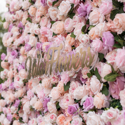 Elevated close-up of Valar Flowers Sunset Romance wall with dense 3D arrangement of roses peonies and hydrangeas in pink peach cream and lavender tones evoking an enchanting sunset garden for spring celebrations outdoor boho weddings and whimsical photo booths