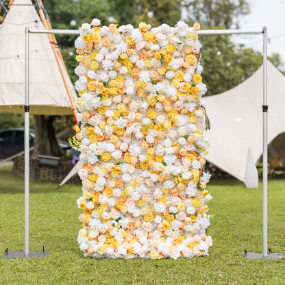 Frontal view of Valar Flowers wall on silver frame: white, buttery yellow, and peach roses on manicured lawn with teepee canopy blurred behind. Sophisticated elegance for outdoor wedding receptions and garden galas.