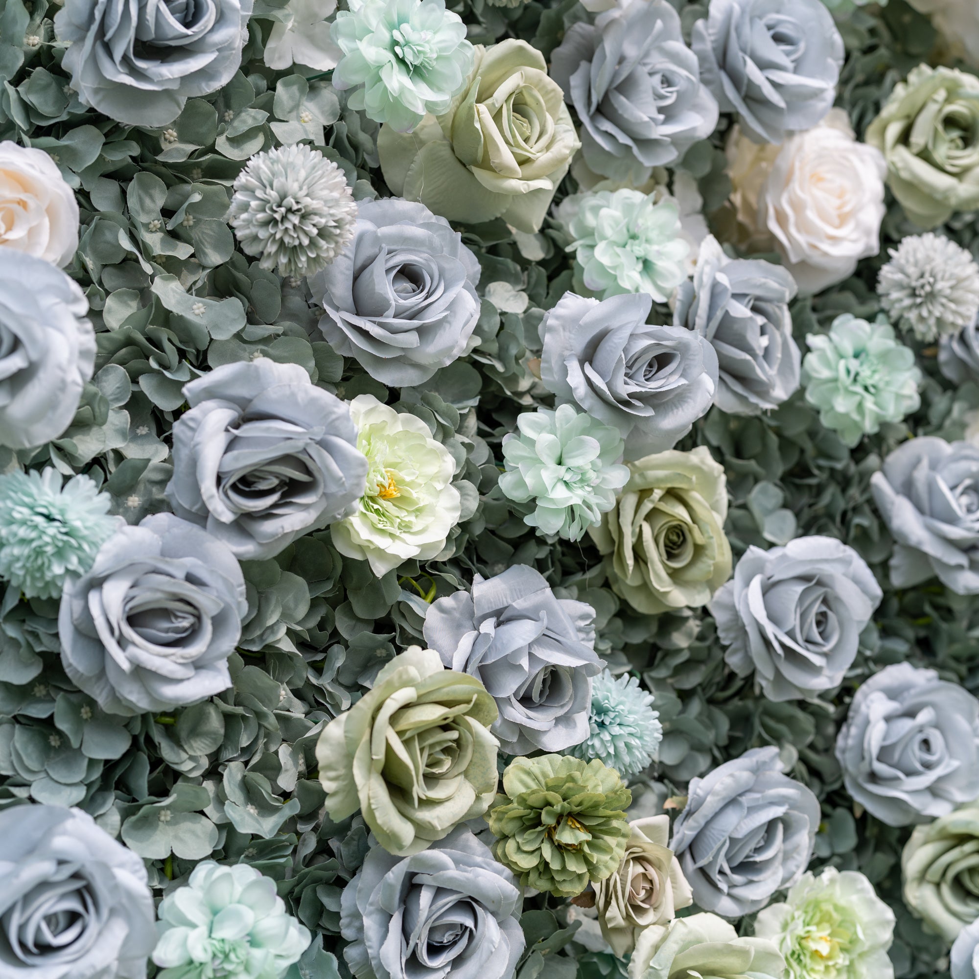 Elevated close-up of Valar Flowers Ethereal Serenity wall with layered roses dahlias and hydrangeas in muted blue sage and cream tones evoking a serene garden feel for spring celebrations outdoor boho weddings and whimsical event photo booths