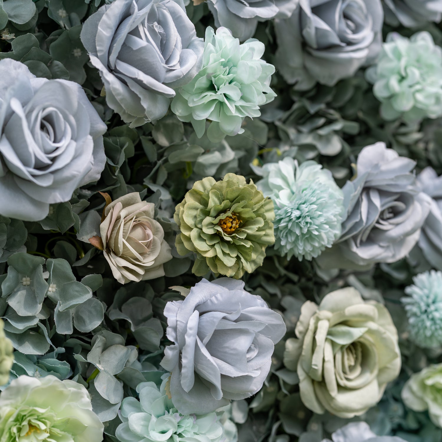 Valar Flowers wall close-up with laser-cut cursive ValerFlowers wooden sign on acrylic among dusty blue white and sage green roses with delicate eucalyptus accents rich layered texture and artisanal charm for rustic-chic weddings and bridal displays