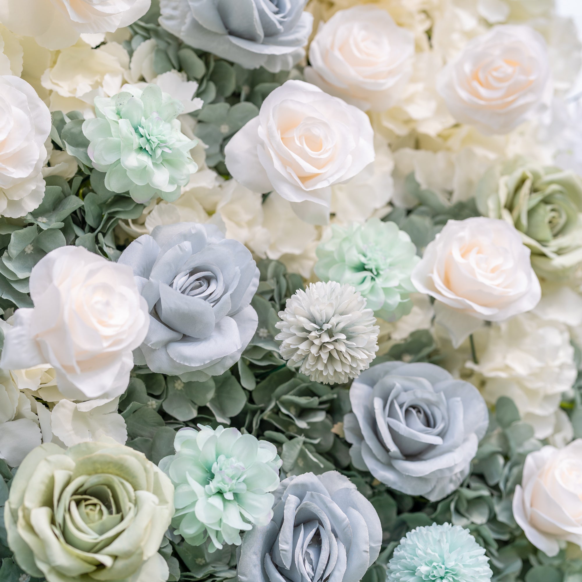 Valar Flowers Ethereal Serenity wall on green lawn with dense dusty blue sage and ivory roses on a silver frame with tents and string lights beyond capturing whimsical boho romance for outdoor garden weddings and lifestyle event photography