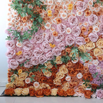 This image showcases a stunning floral wall by Valar Flowers. It features a dense, artful arrangement of artificial roses in a rich palette—soft pinks, warm oranges, and creamy yellows—interspersed with lush green foliage. The flowers create a lush, textured, and visually captivating display, exuding elegance and charm, perfect for adding a touch of sophistication to events or interior spaces.