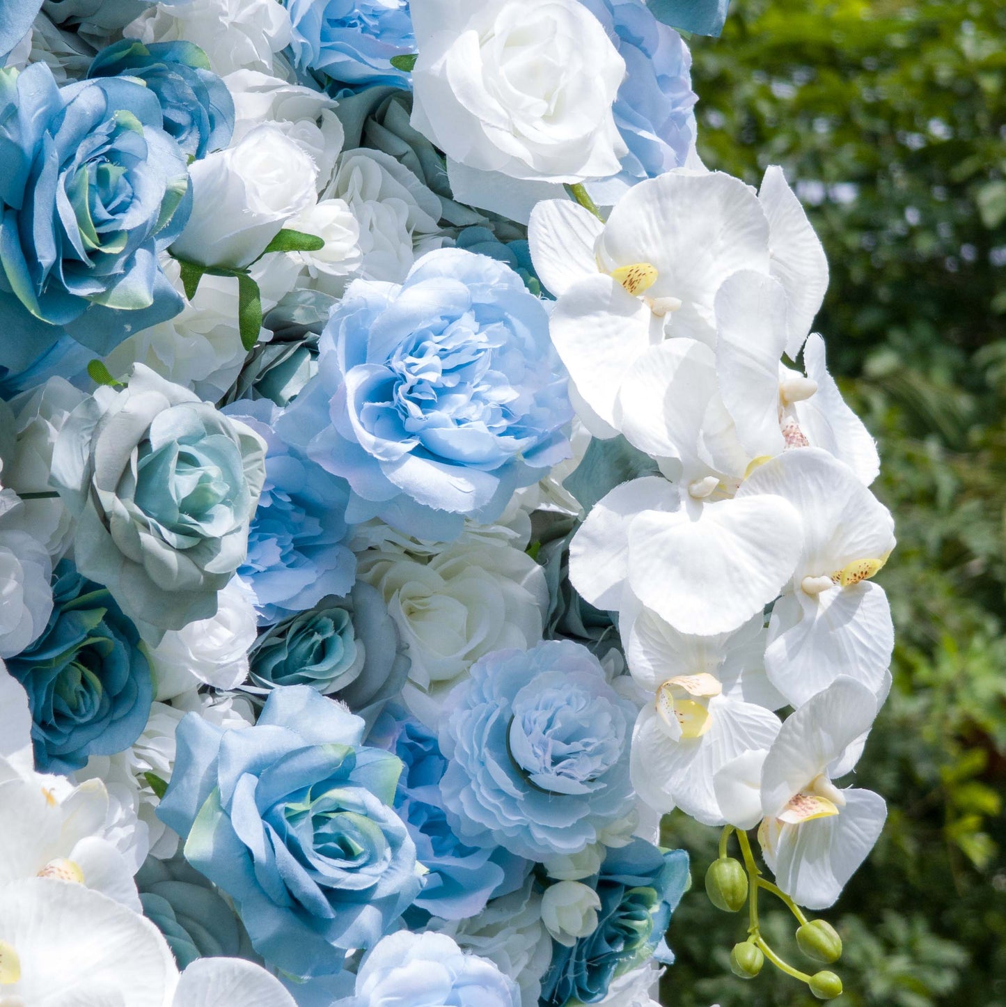 This photo showcases a lush, vibrant floral arrangement featuring a mix of blue and white roses, along with white orchids. The flowers are densely packed, creating a rich, textured display. The soft blues and whites blend harmoniously, evoking a sense of calm and elegance. Ideal for high - end events like weddings or upscale corporate functions, this arrangement exudes sophistication and beauty, making it a stunning focal point for any occasion. 