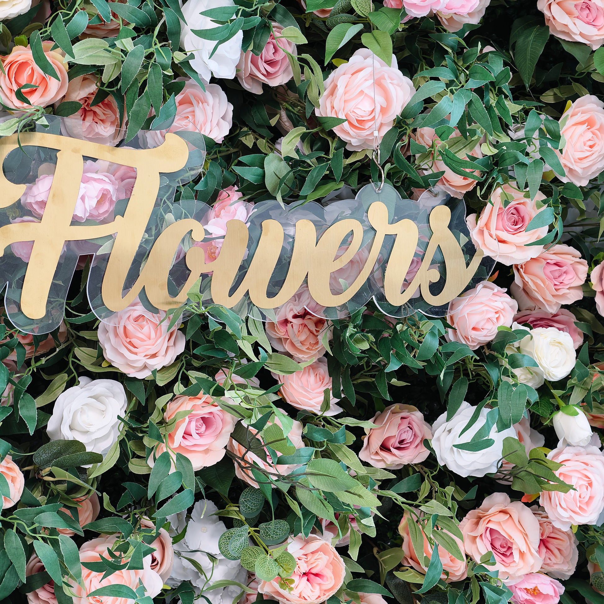 This photo displays a lush floral arrangement with pink and white roses nestled among green foliage. The word "Flowers" in elegant golden lettering on a clear background stands out prominently. Ideal for events like a floral - themed charity brunch or a "Garden of Elegance" bridal event, it exudes a refined and romantic ambiance, perfect for sophisticated and celebratory occasions. 