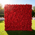 This image features a large, square floral wall outdoors on a lush green lawn. It&