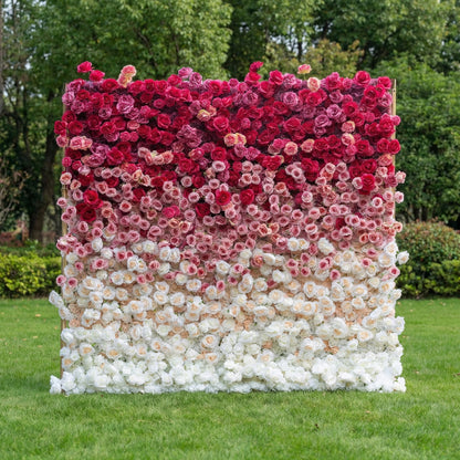 This elegant flower wall from Valar Flowers features a lush, gradient arrangement of blooms in deep red, blush pink, and pure white—including velvety roses and delicate peonies. Set against a sunlit lawn and greenery, the seamless color transition creates a romantic, sophisticated atmosphere ideal for weddings, engagement shoots, or elegant outdoor events.