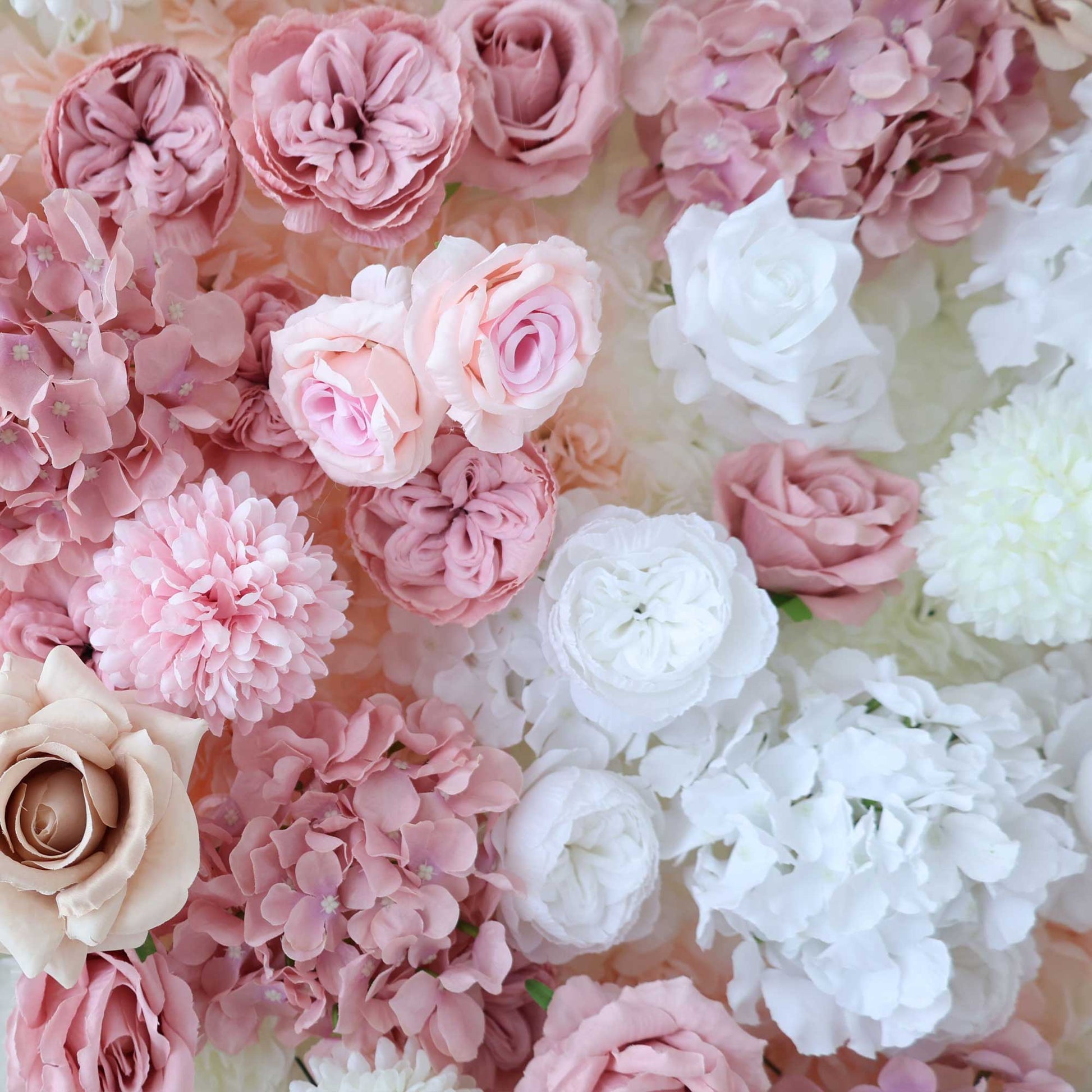 A close - up of a floral arrangement shows an array of white and soft - pink roses, hydrangeas, and other blooms, creating a delicate and romantic visual. 