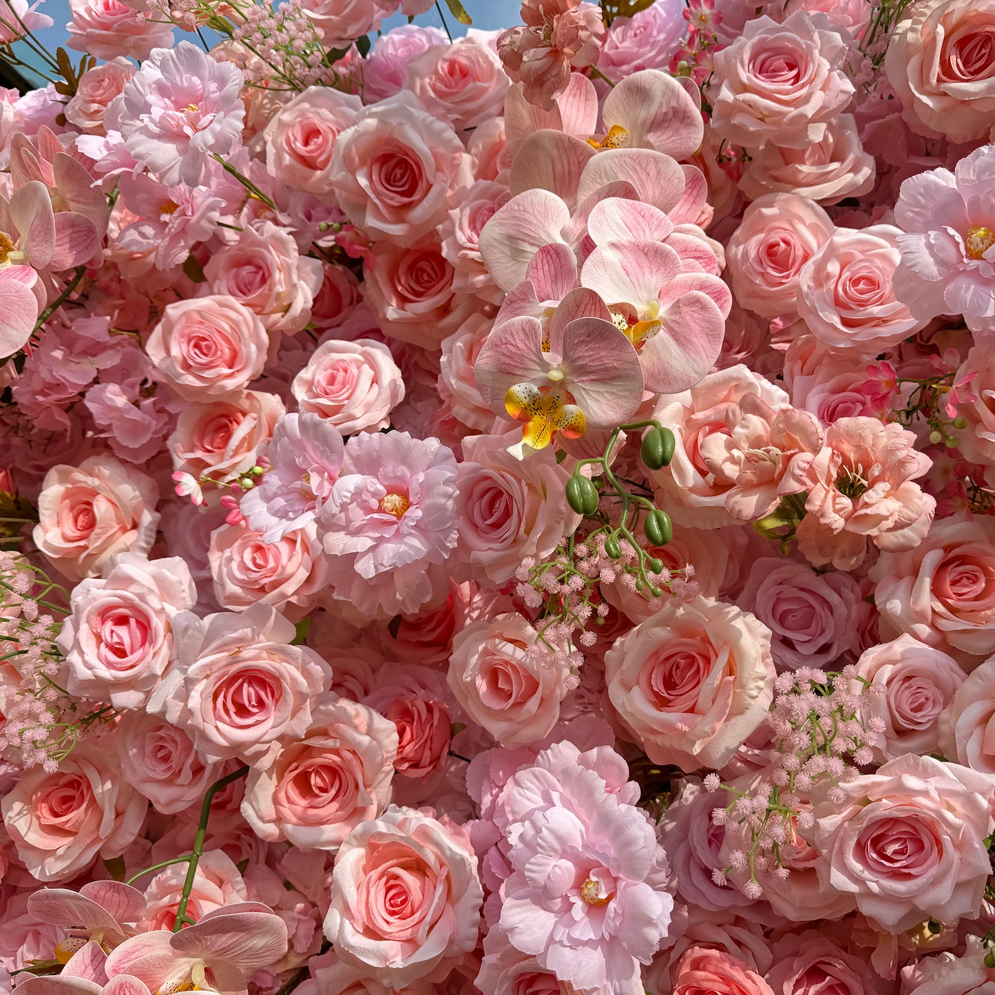 This photo showcases a lush, dense arrangement of soft pink roses, delicate pink orchids, and small pink blossoms. The harmonious blend of pastel - colored flowers creates a gentle and romantic atmosphere. Ideal for events like a "Romantic Pastels" baby shower or an elegant anniversary celebration, it combines the grace of roses and orchids for intimate, refined occasions. 