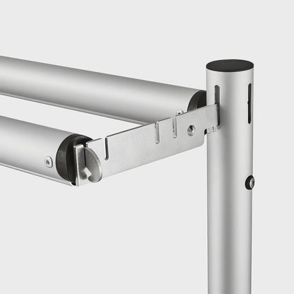 The image shows a close - up of a metal framework connection. Two horizontal poles attach to a vertical one via a metal bracket with holes and connectors, suggesting an adjustable and modular design. 
