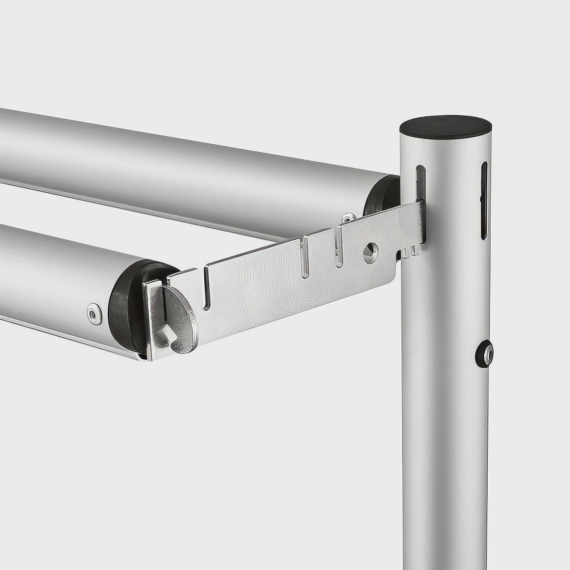 The image depicts a section of a metal framework, likely part of a backdrop stand or similar structure. It features silver - colored metal poles with black end - caps. There is a metal connector piece with multiple holes and slots, which is used to secure the horizontal poles to the vertical pole. This type of connector is essential for assembling and stabilizing the structure, allowing for adjustable and sturdy connections between different parts of the stand. Such components are commonly used in photograp