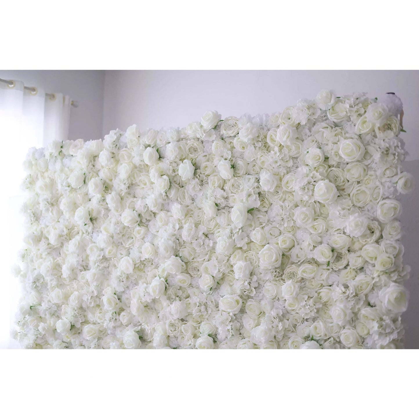 Valar Flowers premium all-white artificial flower wall backdrop featuring a dense arrangement of lush silk roses, hydrangeas, and carnations in an elegant monochromatic ivory palette, perfect for luxury wedding decor and event photo booth backgrounds.