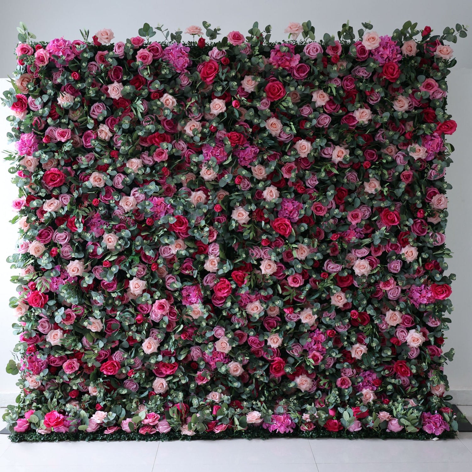 Valar Flowers premium roll-up fabric artificial flower wall backdrop featuring a vibrant mix of silk roses and blossoms, creating a lush, romantic display for weddings, events, and photography.