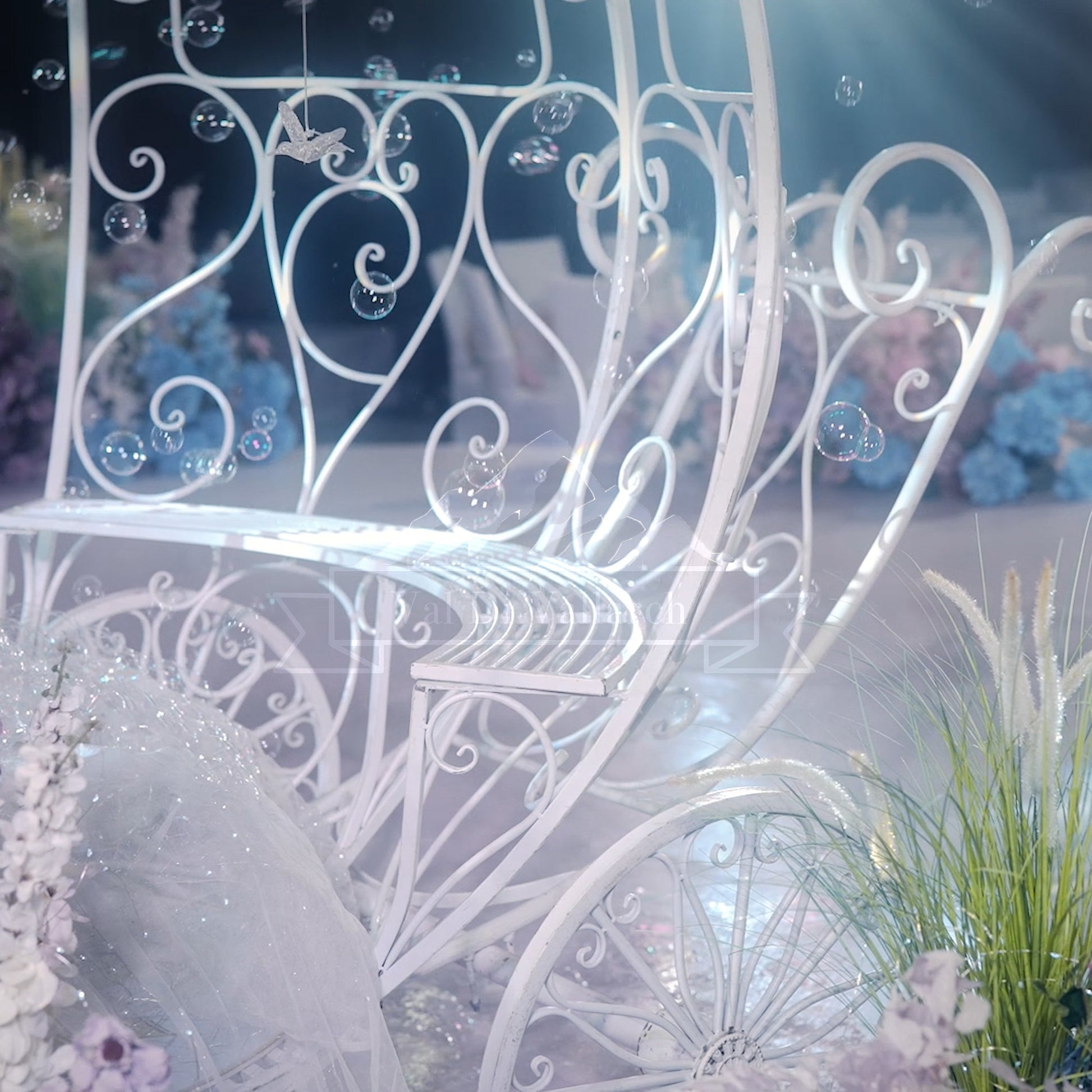 This enchanting image by 'ValarFlowers' showcases a delicately crafted white wrought iron carriage adorned with bubbles and floral decor. Ideal for weddings, romantic photoshoots, or fairytale-themed events.