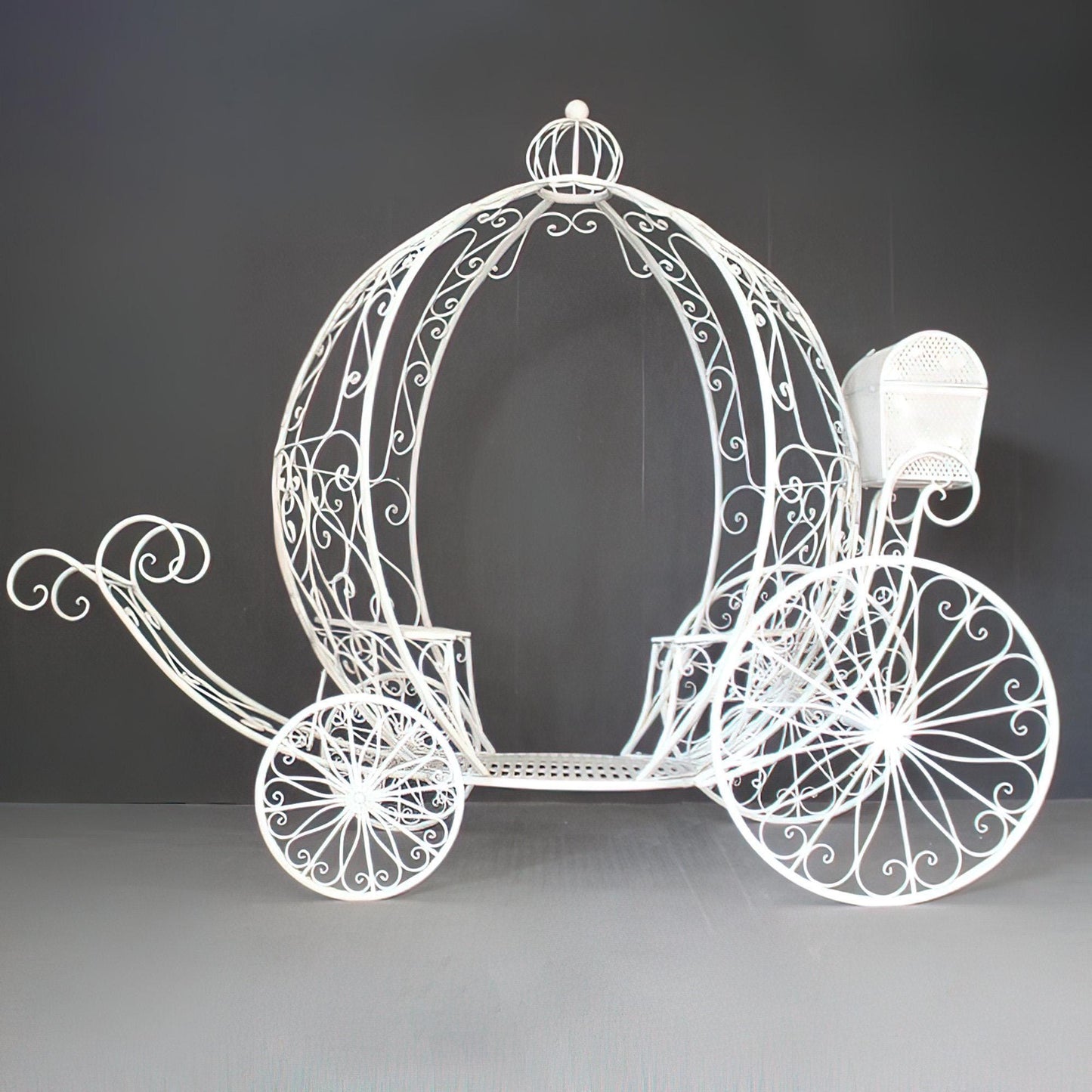 This elegant white metal carriage by 'ValarFlowers' showcases intricate scroll designs and a classic fairytale silhouette, ideal for weddings, events, or whimsical decor displays.