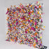 This image showcases a vibrant floral wall densely packed with a variety of artificial flowers. The color palette is rich and diverse, including shades of orange, pink, purple, blue, white, and yellow. The flowers appear to be a mix of roses, daisies, and other assorted blooms, creating a lively and cheerful style. The overall arrangement is lush and eye - catching, ideal for events or photo backdrops. 