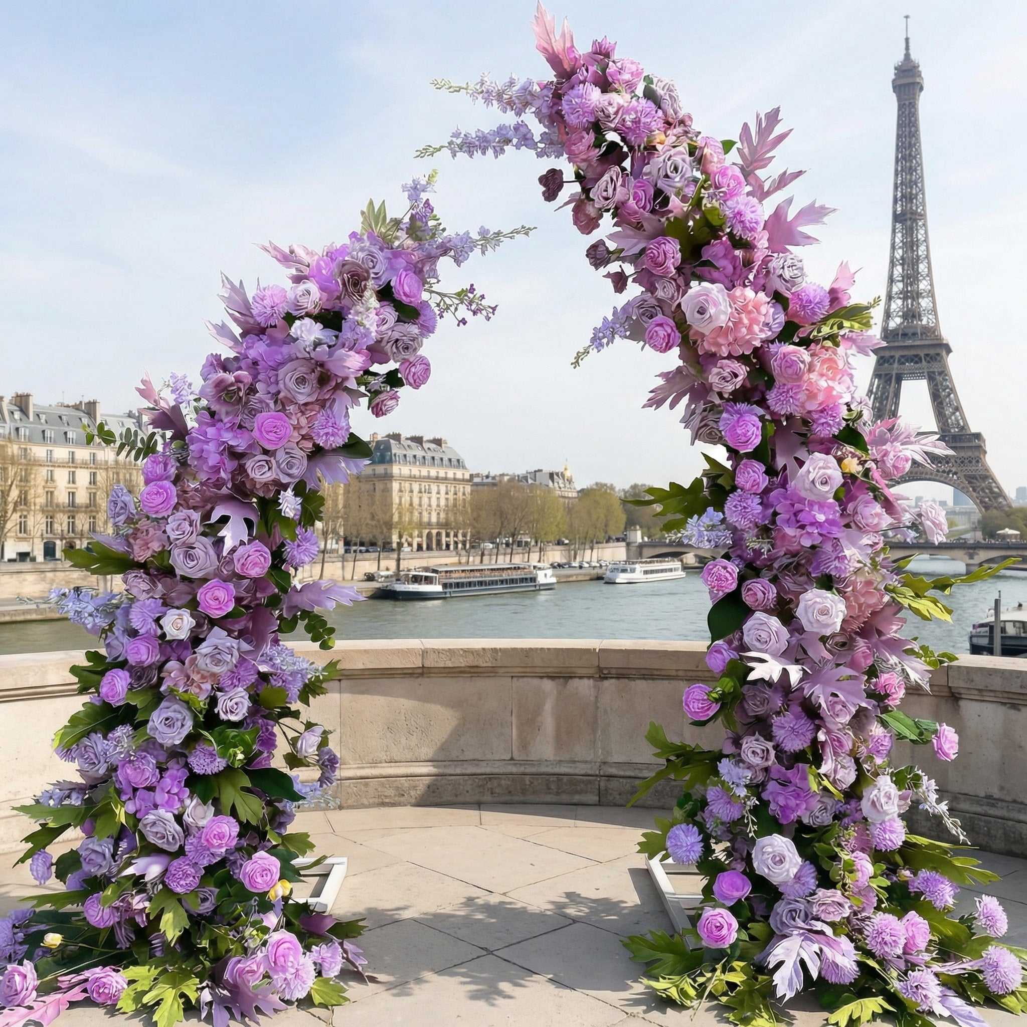 A romantic, asymmetrical floral arch from Valar Flowers, crafted with a dreamy palette of lavender, soft pink, and blush blooms—including roses, peonies, and delicate foliage—intertwined with lush greenery. Set on a sunlit Parisian riverside terrace with the iconic Eiffel Tower in the background, it creates a whimsical, elegant, and sophisticated atmosphere perfect for luxury weddings and editorial photoshoots.